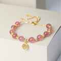 Women's strawberry quartz crystal bracelet with electroplated fu character charm and geometric design
