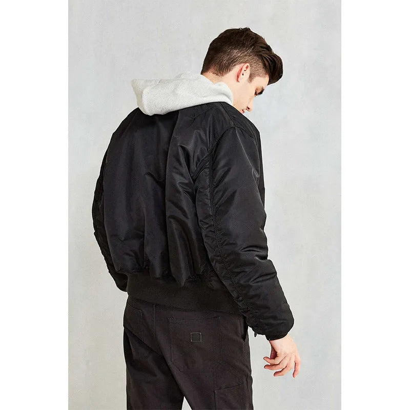 Men's army green loose fit cotton-padded pilot jacket with a double-sided construction on a hanger.