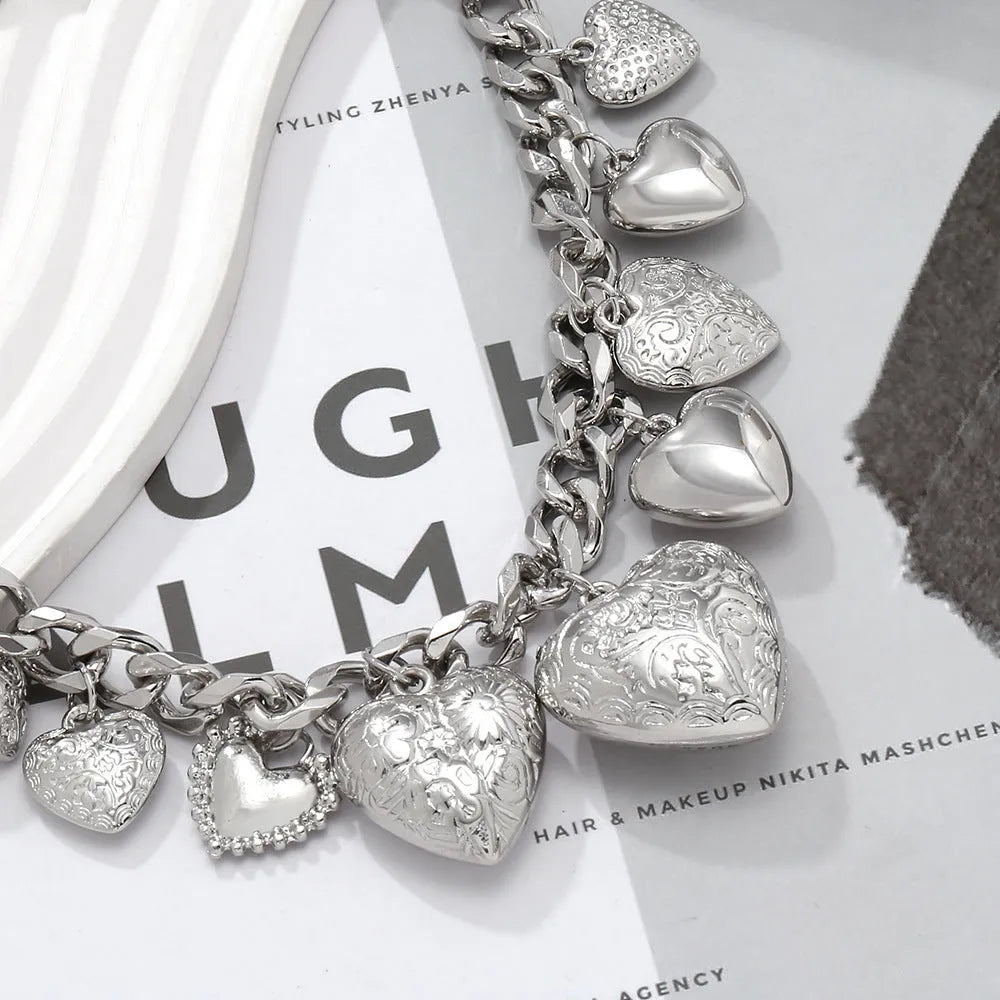 Exaggerated gold heart pendant necklace on a model, showing adjustable chain length.