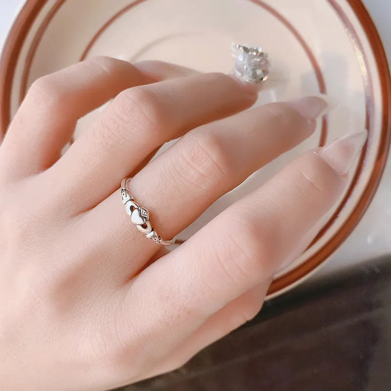 Retro silver women's open ring with a heart shape on a copper band.