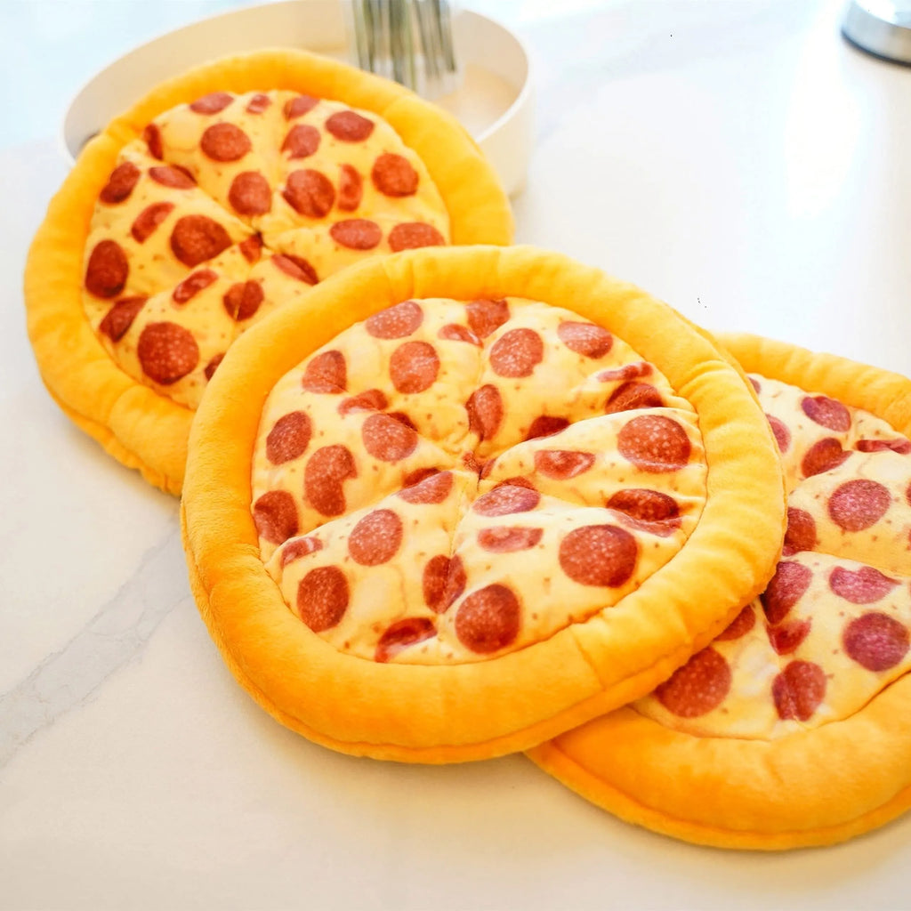 Yellow rubber pizza-shaped dog chew toy with squeaker for interactive play.