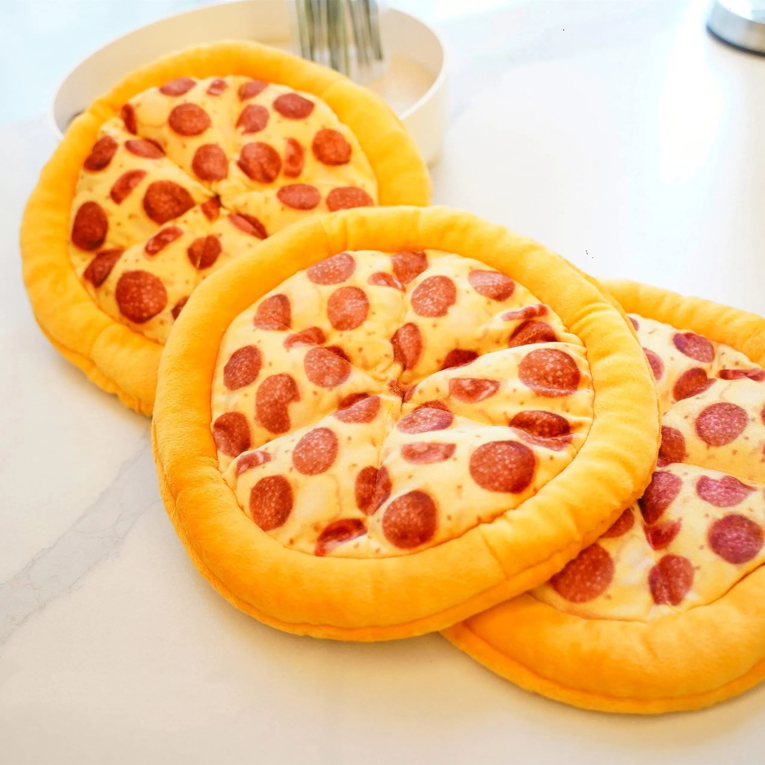 Yellow rubber pizza-shaped dog chew toy with squeaker for interactive play.