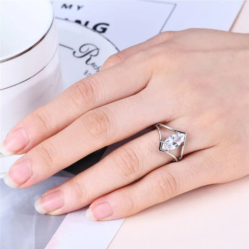 Personalised ling-shaped zircon ring for women, copper construction, white colour option, shown on finger