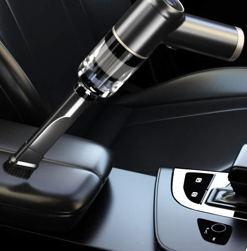 Black wireless handheld car vacuum cleaner with multiple nozzle attachments on charging cable