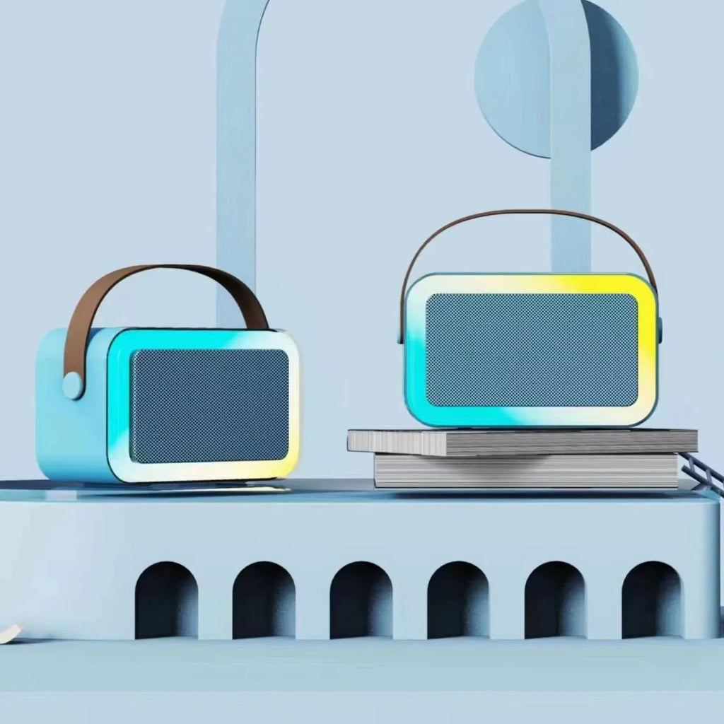 White portable Bluetooth karaoke speaker with coloured lights and a handheld microphone.