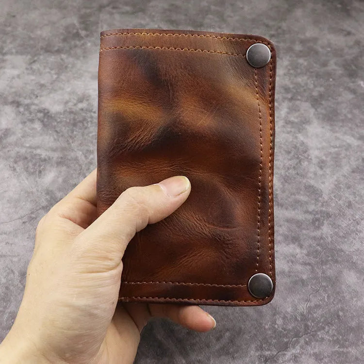 Men's retro style vertical long wallet in genuine cowhide leather showing multiple internal card slots and compartments.
