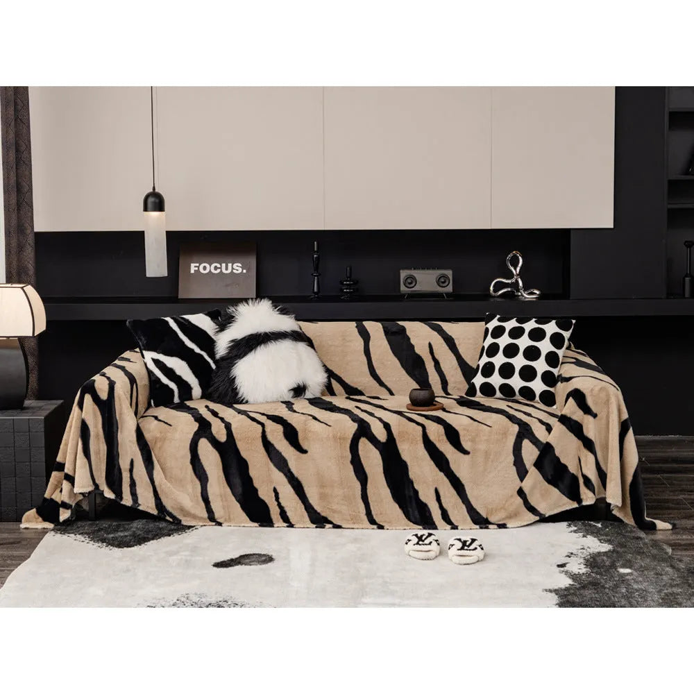Zebra pattern flannel sofa cover in caramel colour, laid flat showing its size and non-slip textured fabric.