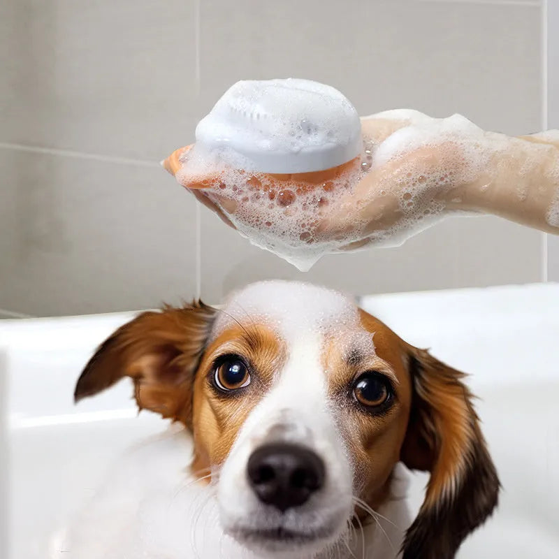 Orange TPR dog bath brush with shampoo dispenser, massage bristles and comb teeth.