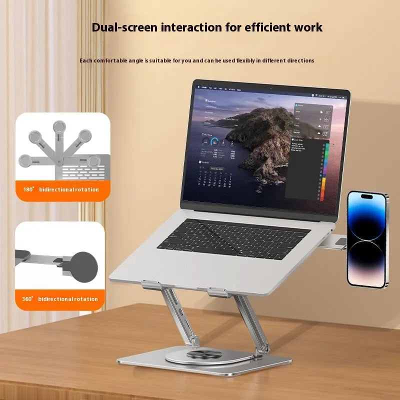 Silver carbon steel laptop stand with rotatable base and a side-mounted magnetic phone holder on a desk.