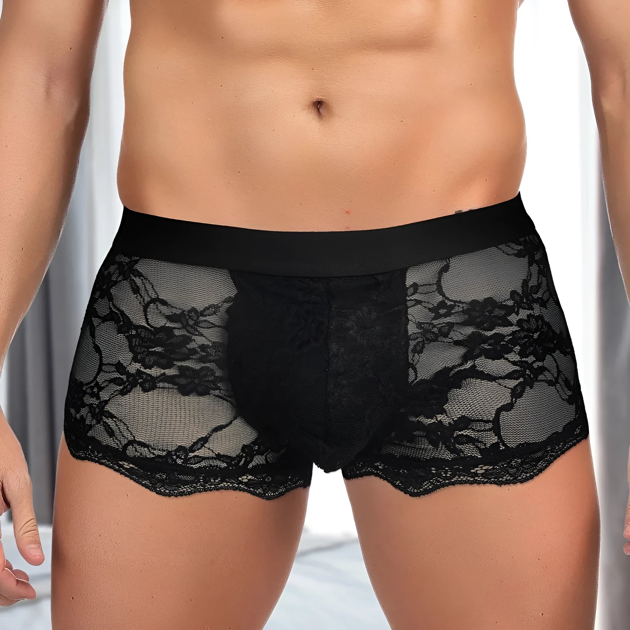 Men's black lace briefs with hollow-out see-through panels laid flat