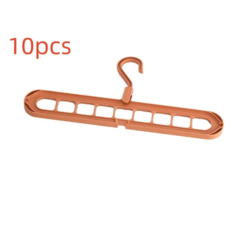 A green plastic folding hanger with nine holes for holding trousers or skirts.