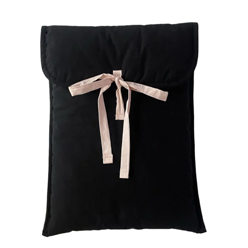 Black and white quilted women's laptop bag with a large decorative ballet bow on the front.
