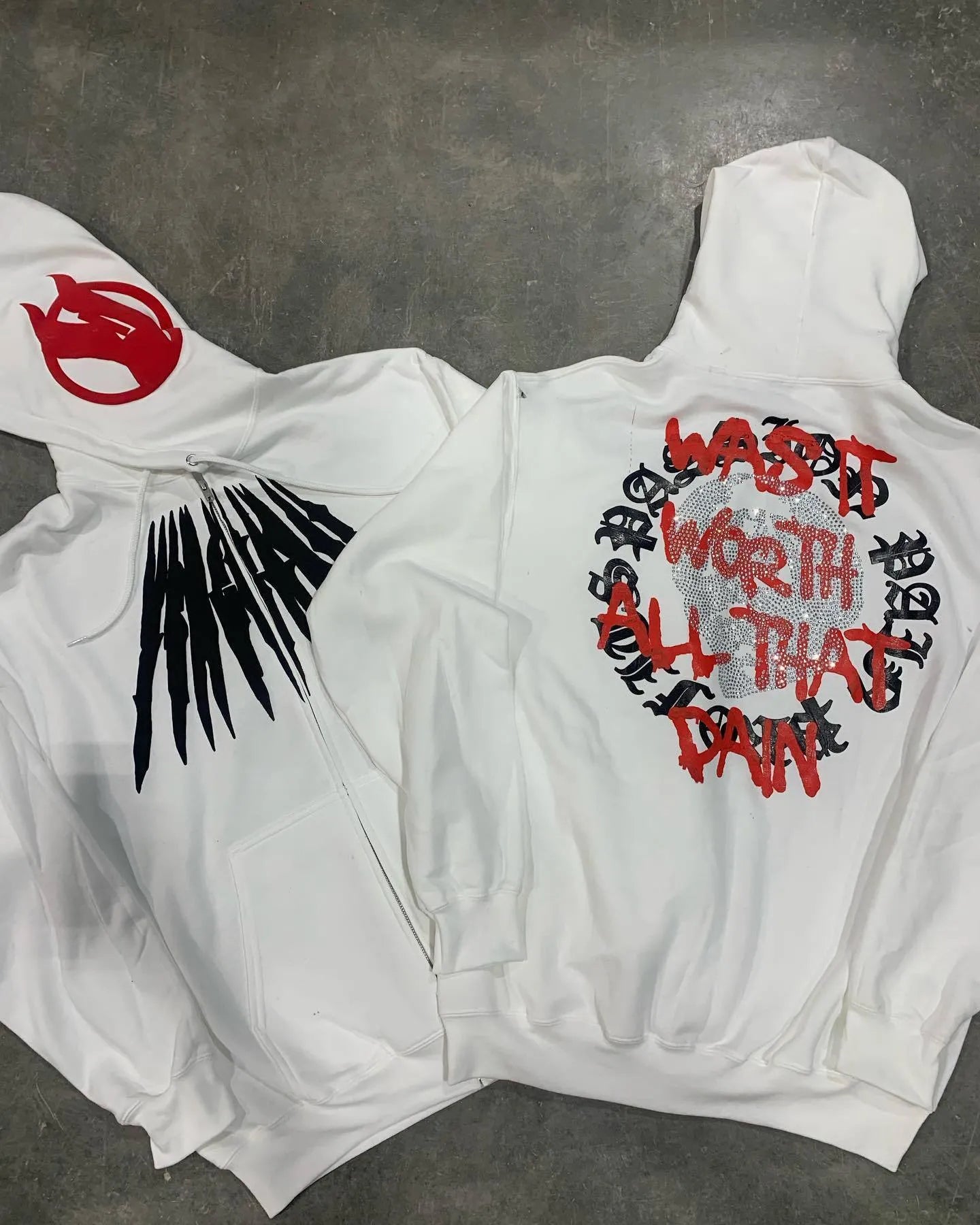 Black hooded sweatshirt with white skull print and rhinestone details in loose cardigan style