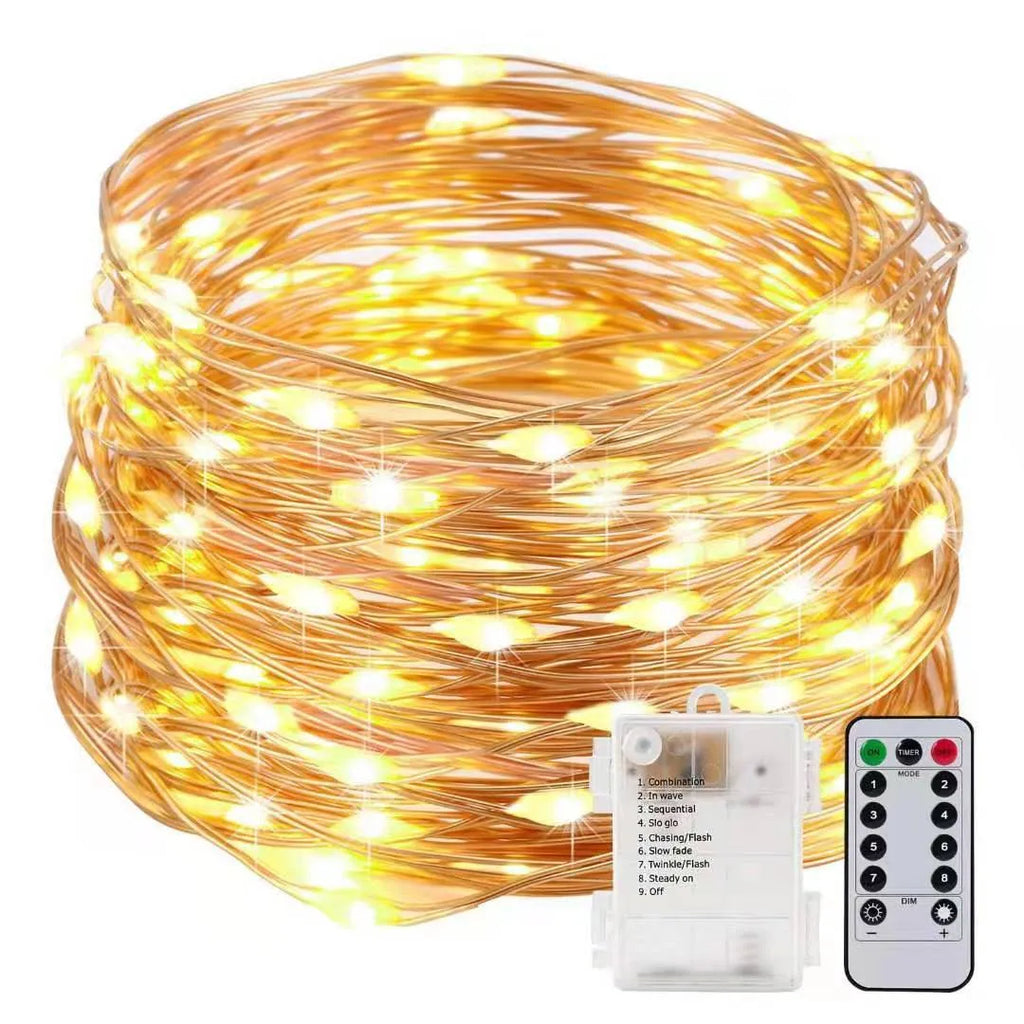 Copper wire LED string light with 120 bulbs, coiled to show its 12-metre length and battery box with USB cable.