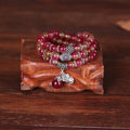 Natural watermelon crystal bracelet with Chinese knot design showing elephant style beads