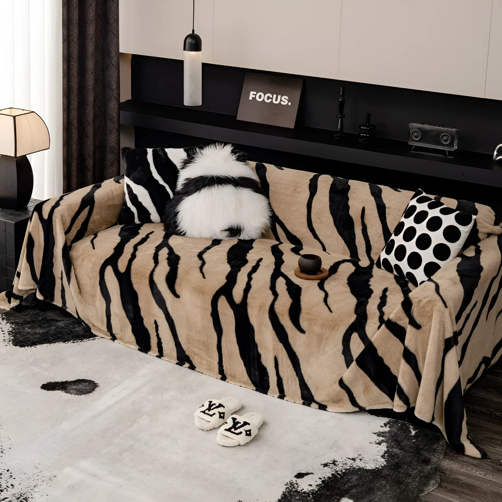 Zebra pattern flannel sofa cover in caramel colour, laid flat showing its size and non-slip textured fabric.