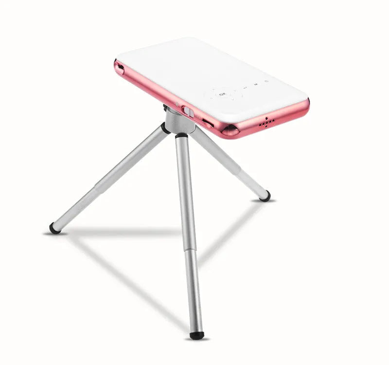 White and rose gold M6S miniature portable Android DLP smart projector on a table.