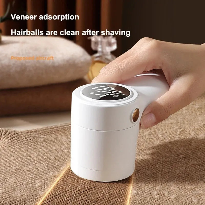 White USB rechargeable electric lint remover and fabric shaver with LED display on a grey background.