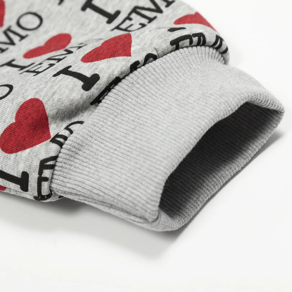 Women's melange grey cotton cardigan with a retro pattern and hood on a hanger.