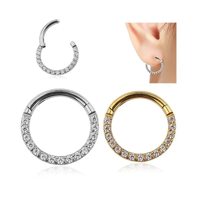 A round stainless steel seamless nose ring on a grey background, shown in a gold plated finish.