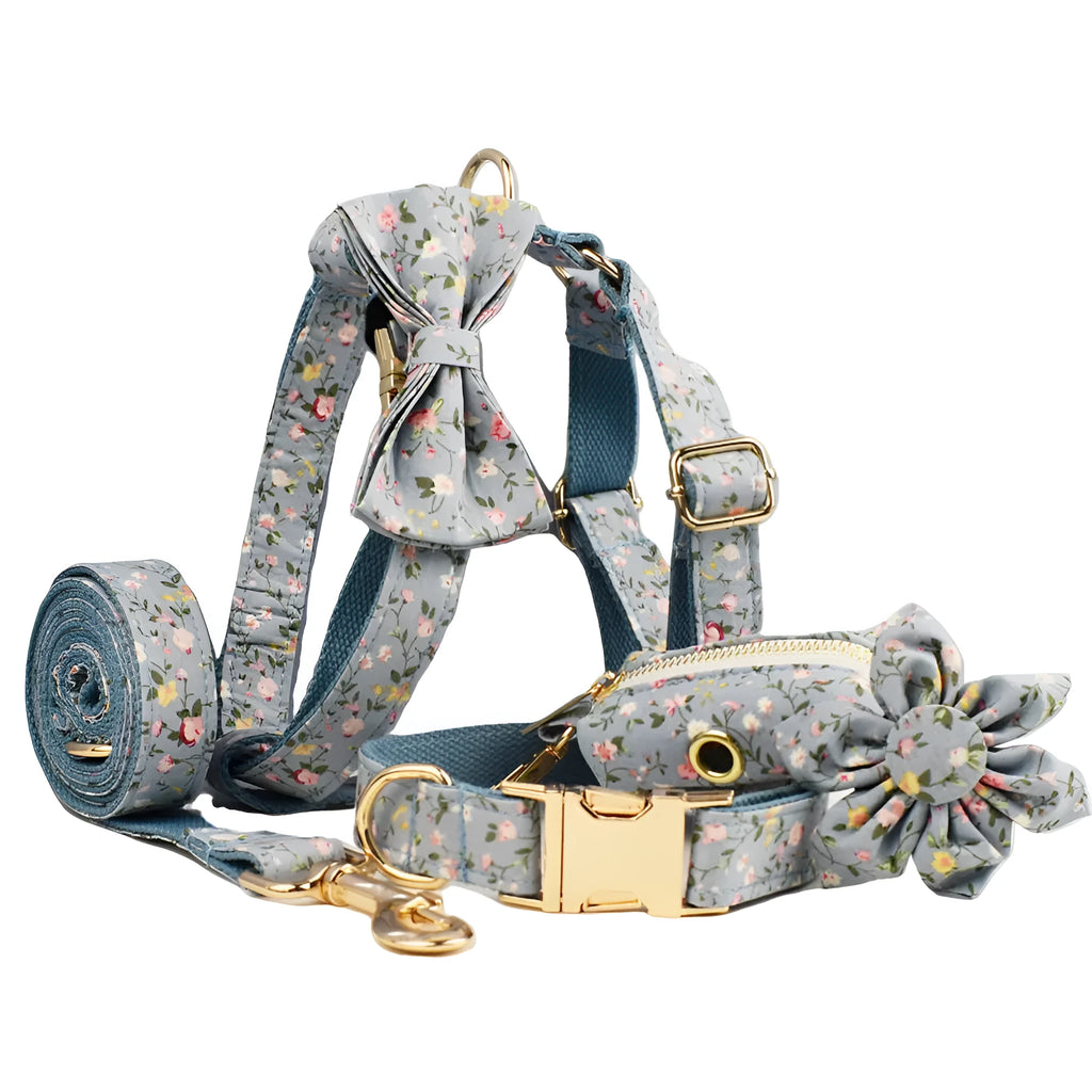 Blue floral patterned adjustable dog collar with matching leash, bow, and vest on a white background.