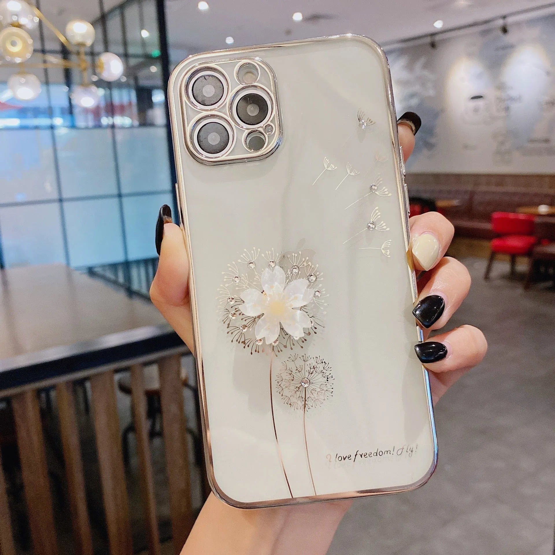 Green iPhone case with a 3D white flower spin stand on the back, showing the built-in screen protector.