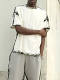 White casual short sleeve polyester top with draped design and printed elements on regular fit model