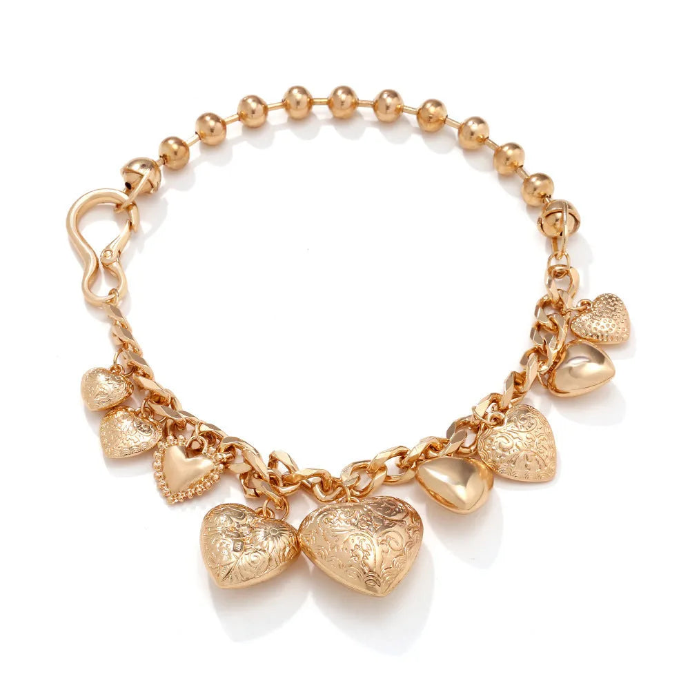 Exaggerated gold heart pendant necklace on a model, showing adjustable chain length.
