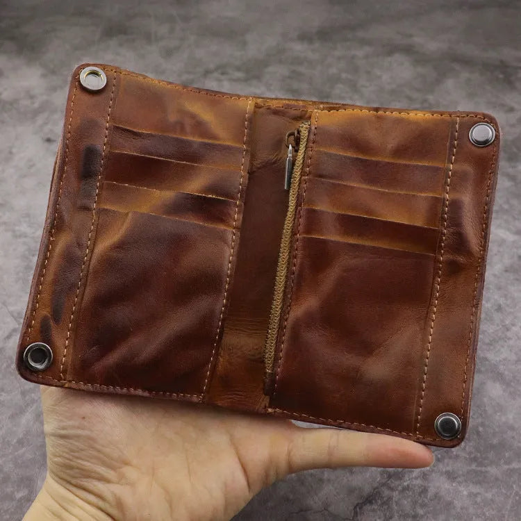Men's retro style vertical long wallet in genuine cowhide leather showing multiple internal card slots and compartments.