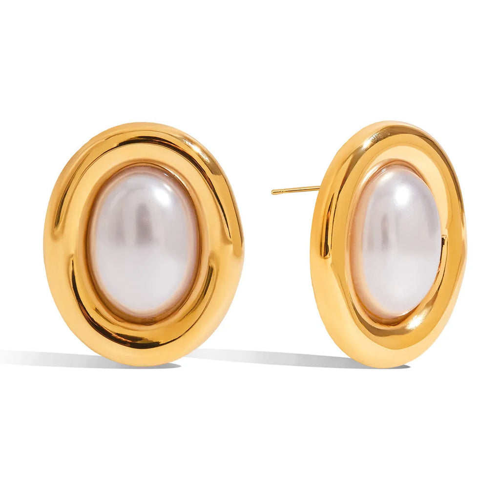 Close-up of a pair of women's stainless steel vintage pearl ear studs with a silver-toned post on a white background.