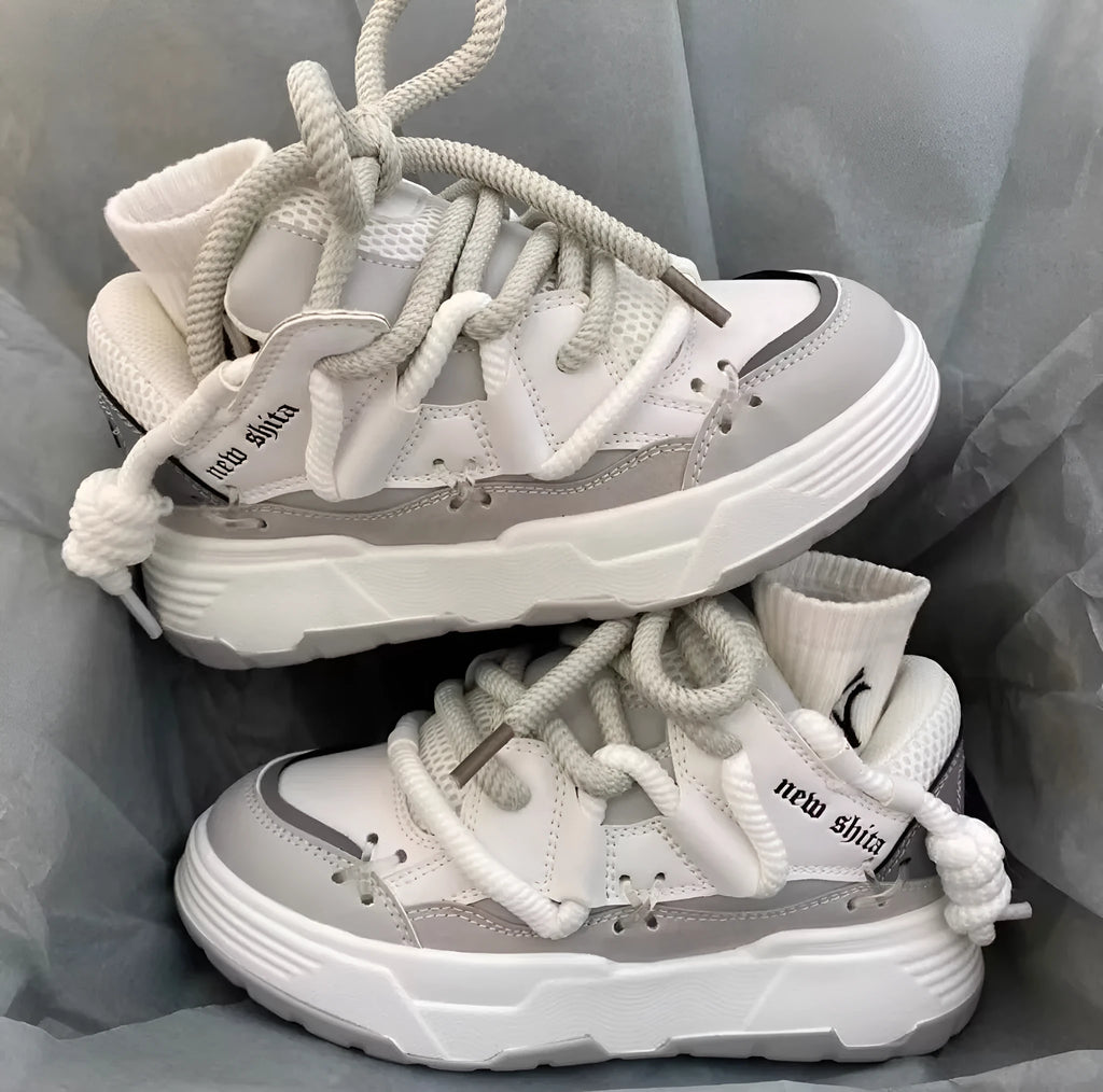Women's grey retro chunky sneakers with thick rubber platform sole and front lace-up closure