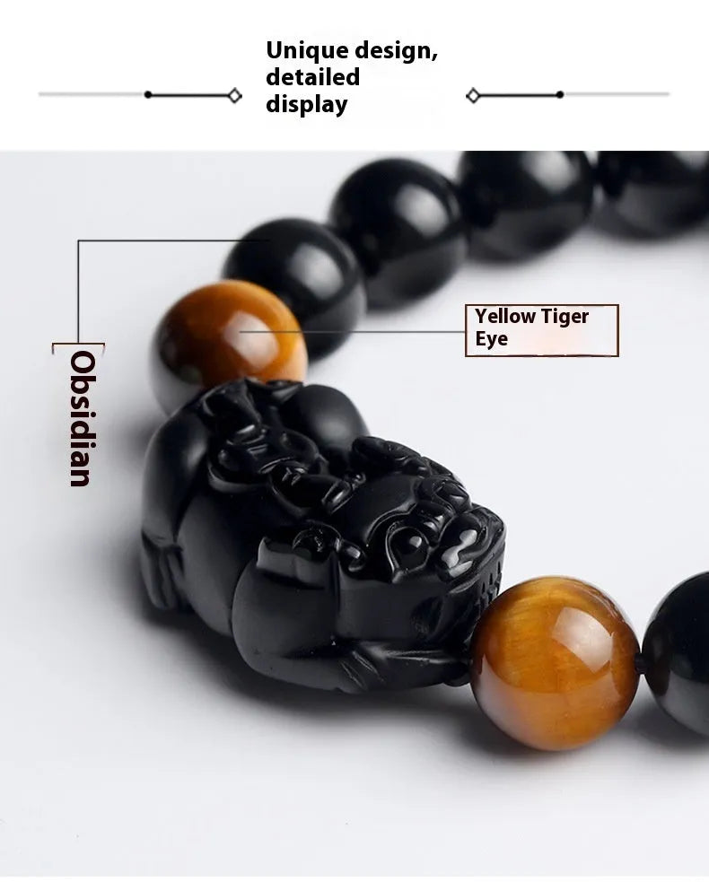 Mexico gold sheen obsidian Pi Xiu bracelet in unisex ethnic style on a wrist.