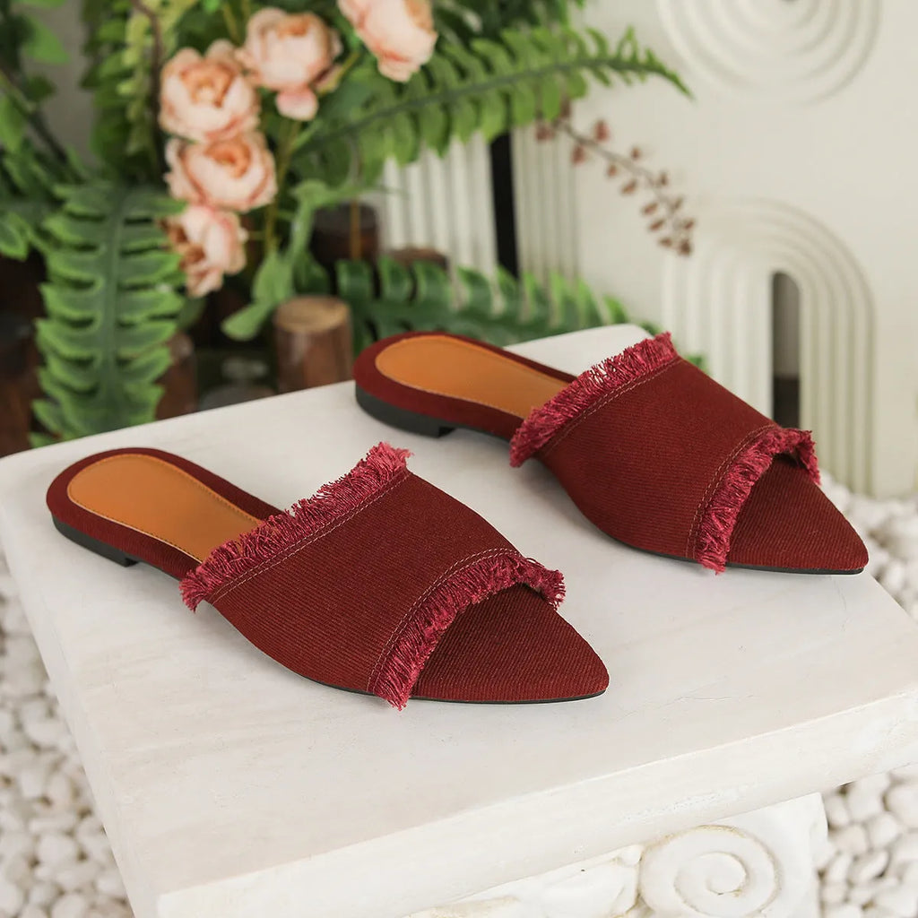 Women's flat denim slippers with a tassel detail in apricot colour on a white background