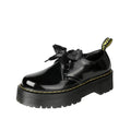 Black women's lace-up shoes with a thick sole, ribbon detail, and cross straps.