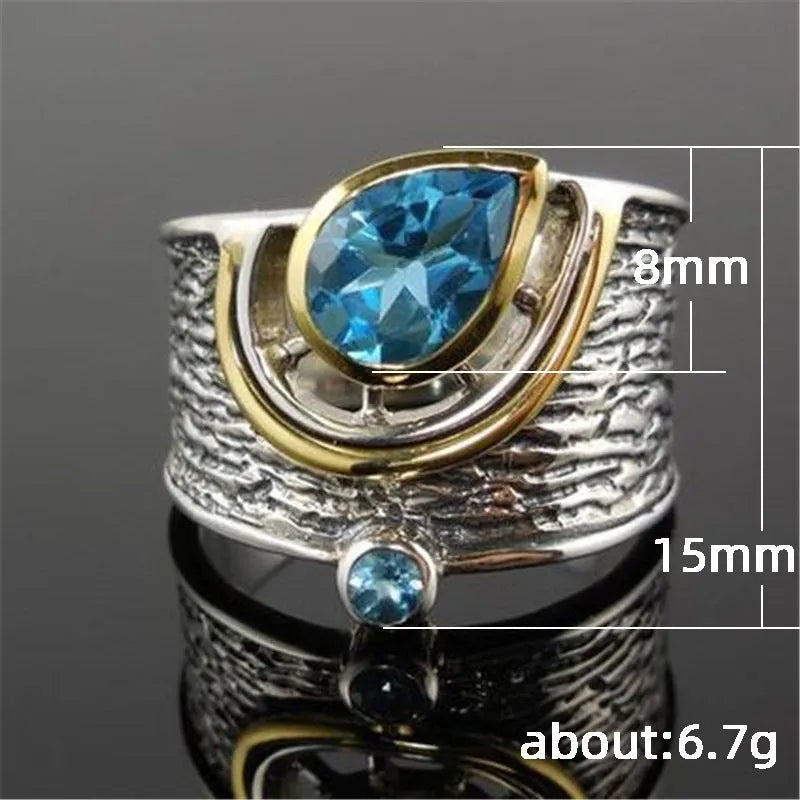 Close-up of a women's blue zircon rhinestone ring in a creative Chinese style drop shape design.