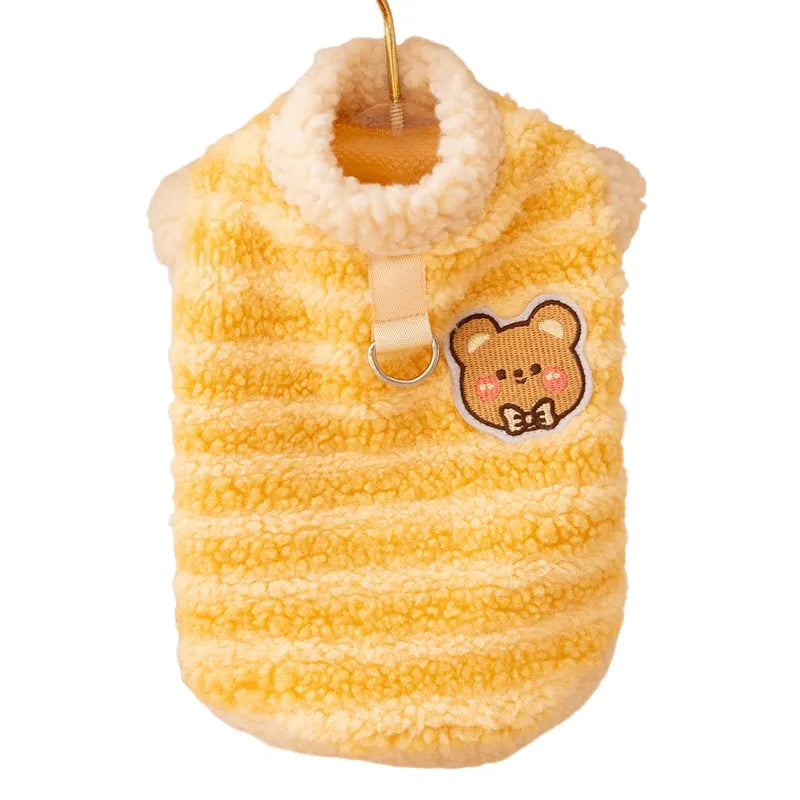 Yellow striped lambskin fleece dog clothing with bear patch and leash ring on a small dog