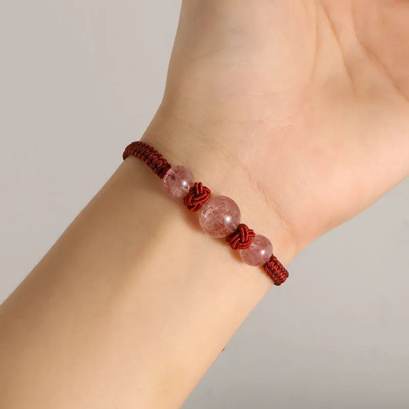 Woven rope bracelet with spherical strawberry quartz beads and alloy accents