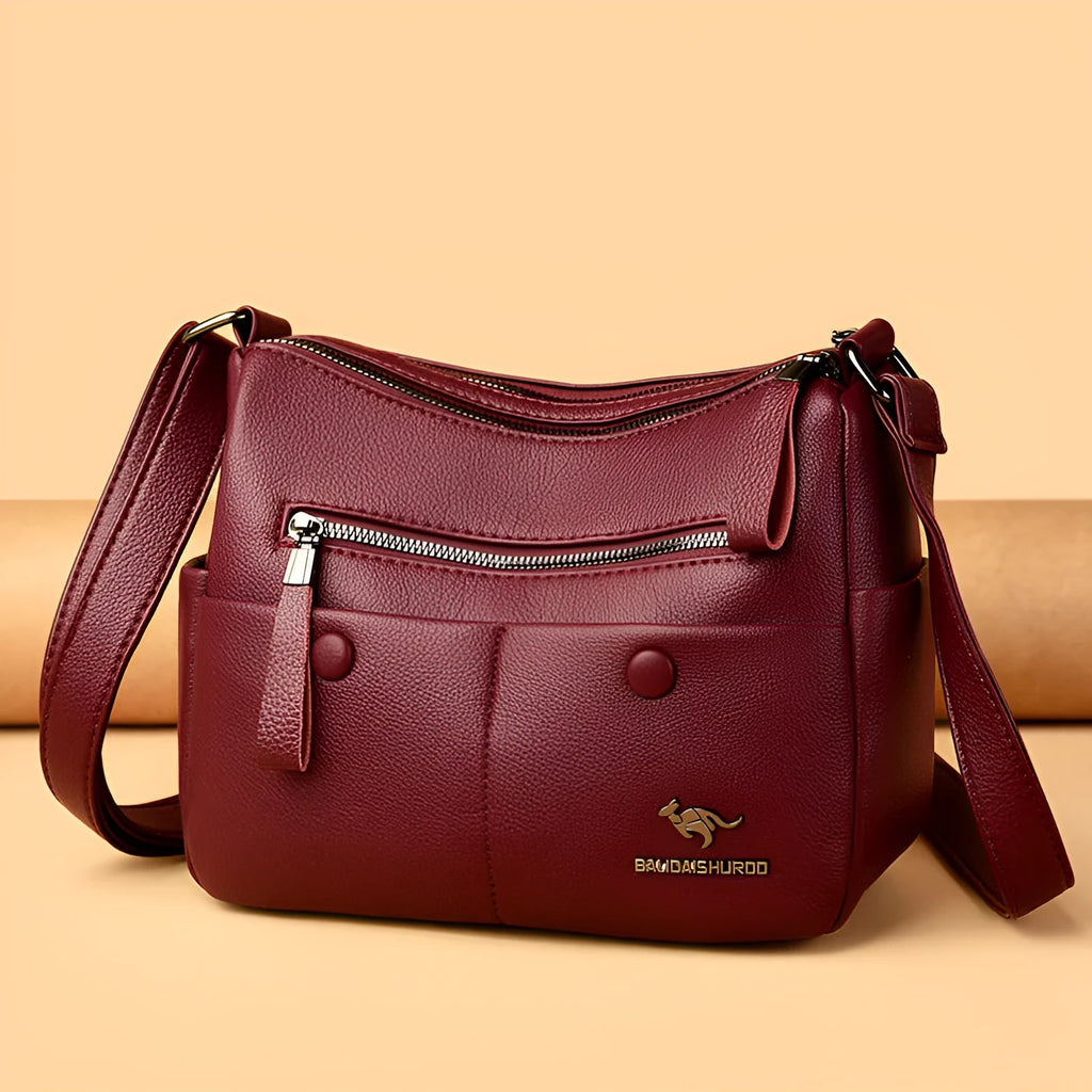 Soft PU leather crossbody shoulder bag in horizontal square shape with stitching details and multiple compartments