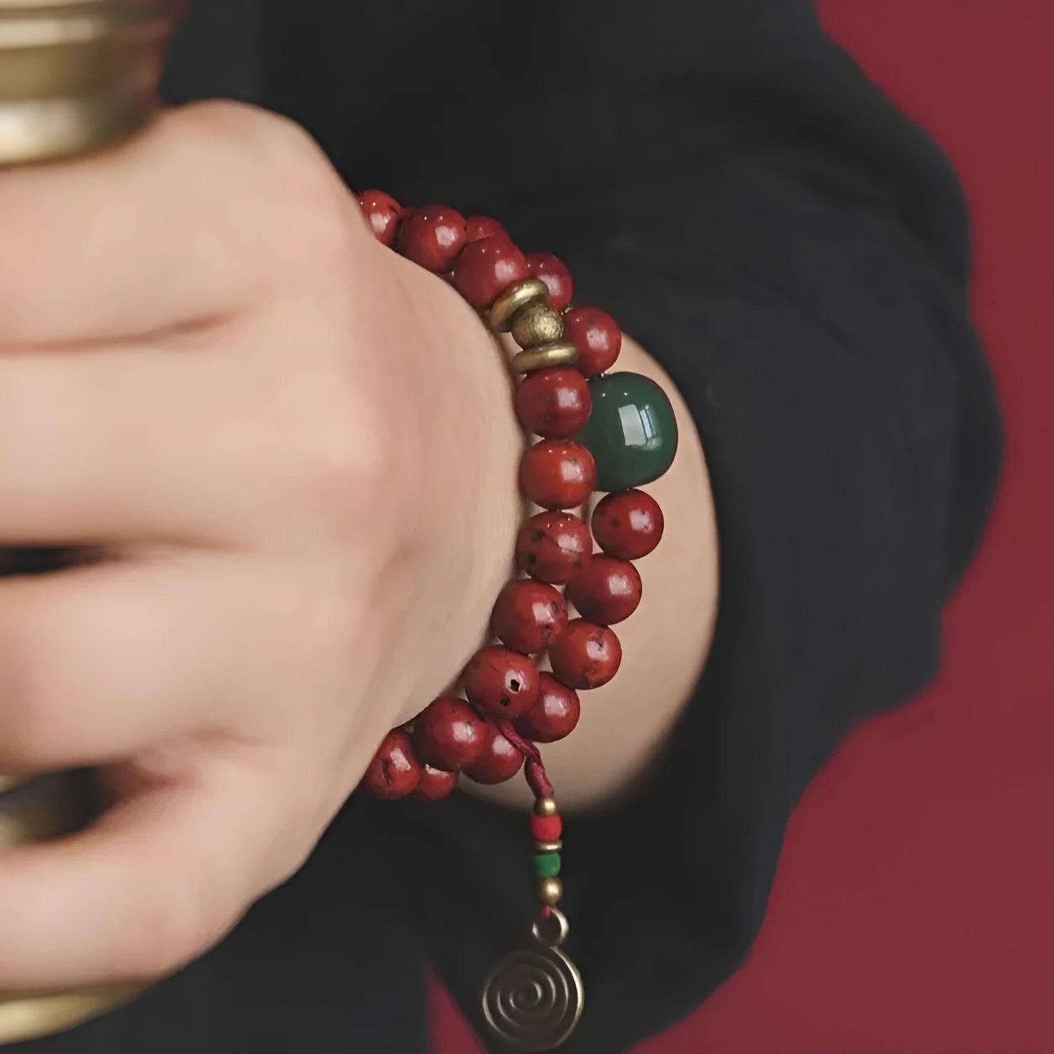 Close-up of a handmade double circle bracelet crafted from brown bodhi seeds on a wrist.