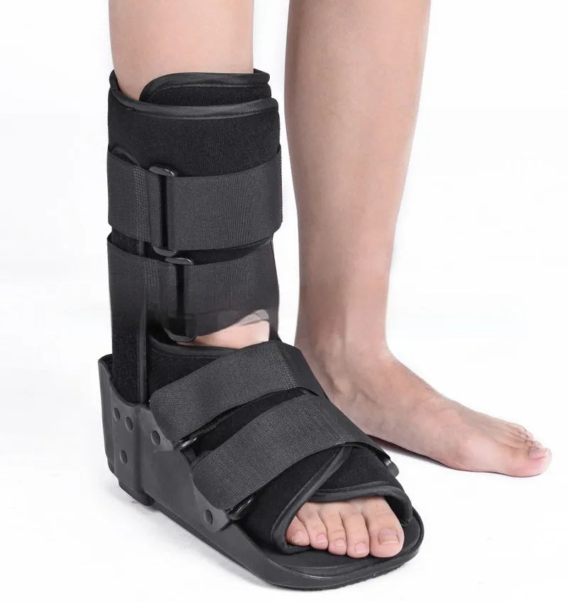Grey and black Achilles tendon rehabilitation boot with adjustable straps and a rigid plastic shell