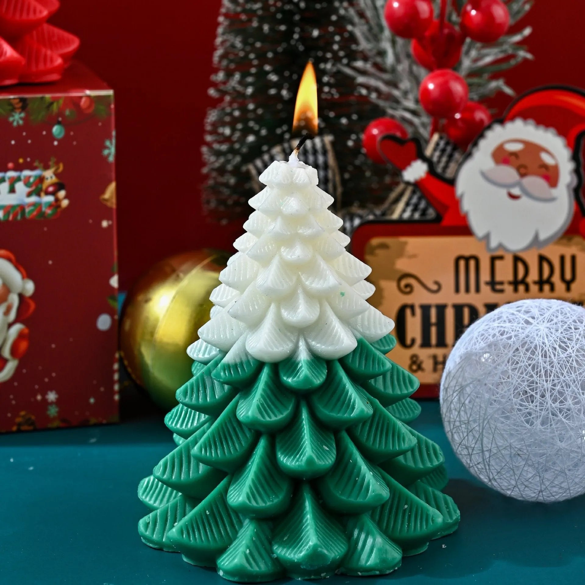 Christmas tree shaped soy wax aromatherapy candle in green on a table with festive home decoration