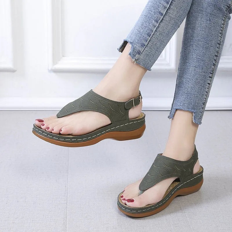 Women's red casual wedge heel sandals with an adjustable buckle strap on a white background.