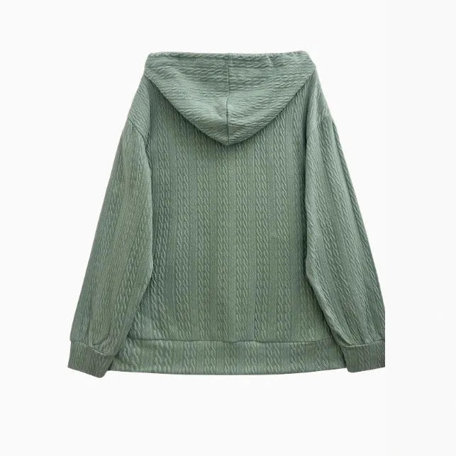 Green women's hooded sweater coat with a front zipper on a hanger