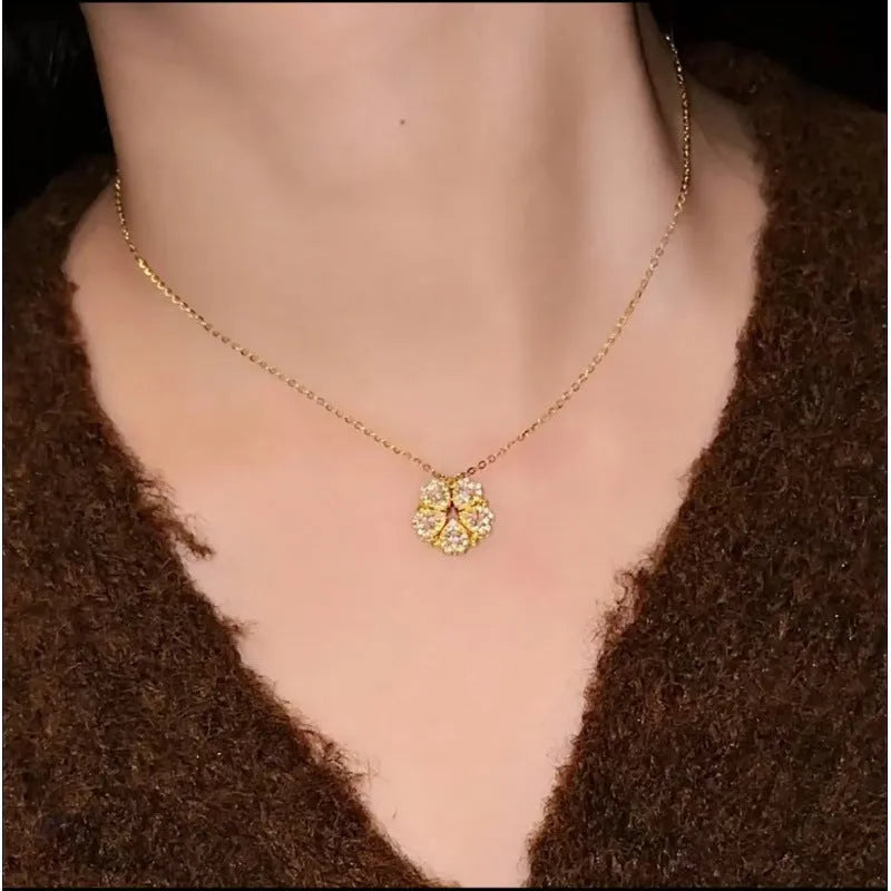 Dual-wear summer mori necklace with copper heart pendant and flower elements in gold colour on woman
