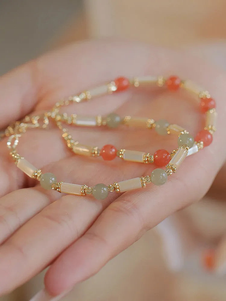 Women's bamboo design bracelet with 6mm Hetian jade beads in either jade or South Red colour.
