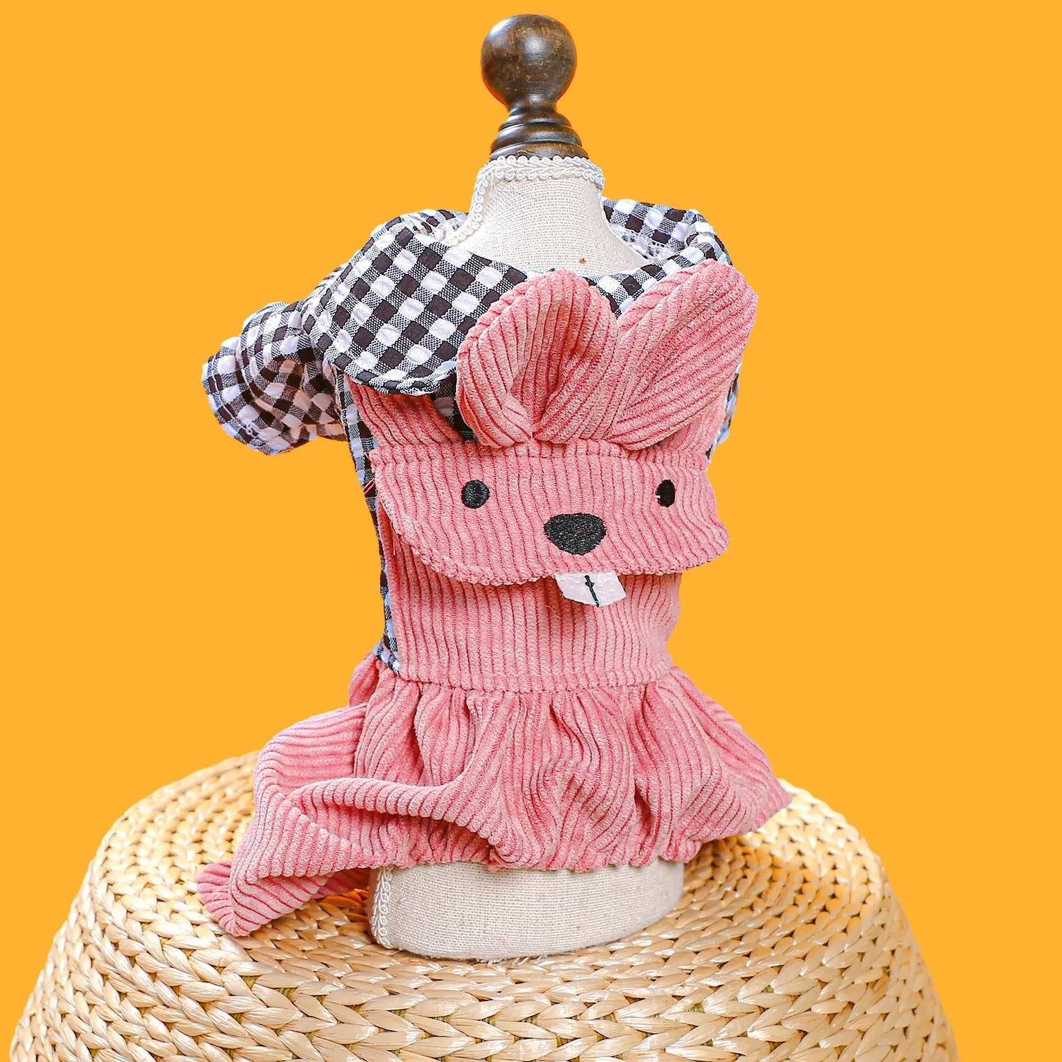 Four-legged plaid polyester pet overalls in black grid top, with full leg coverage, on a light background