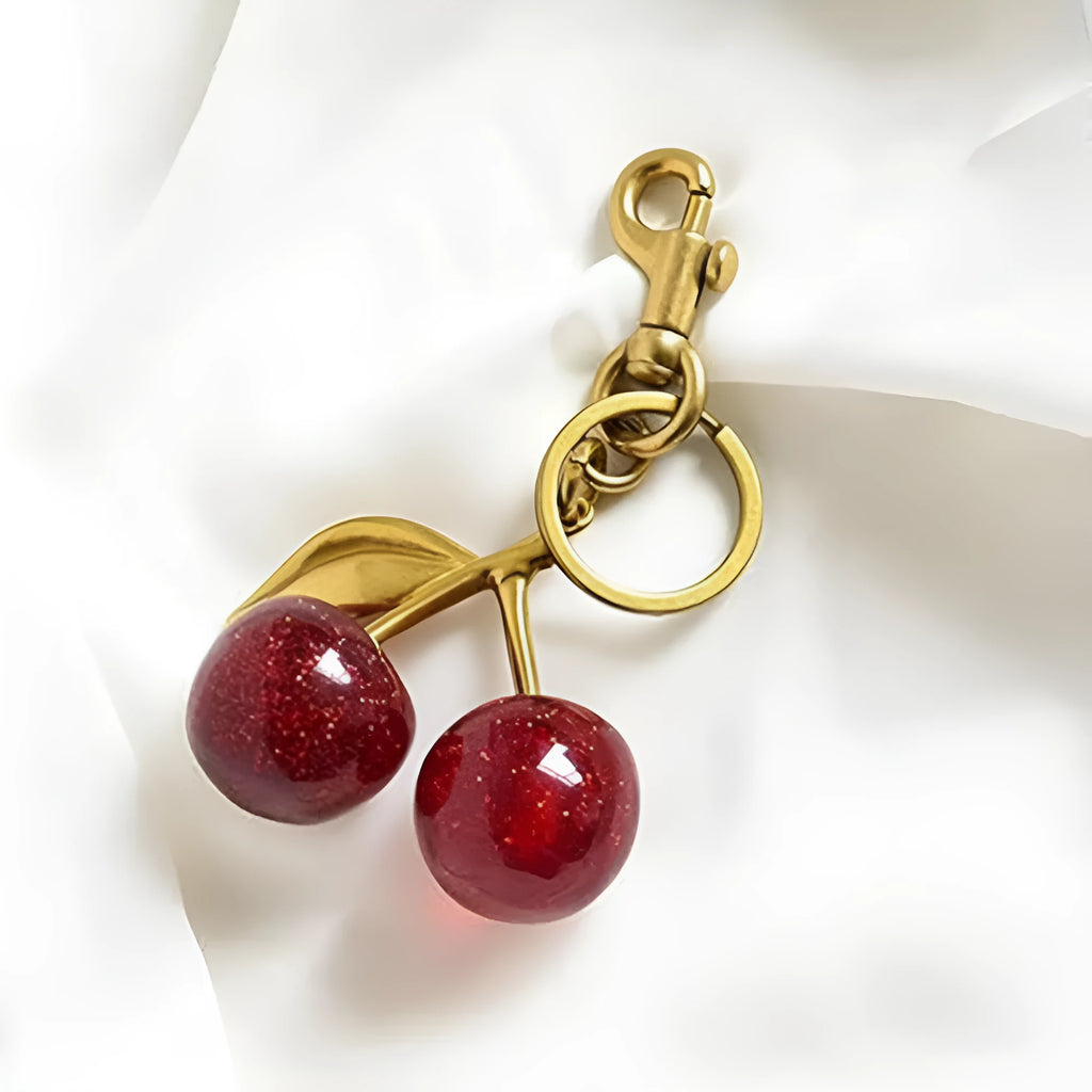 Red cherry-shaped zinc alloy keychain pendant with three-dimensional design on white background