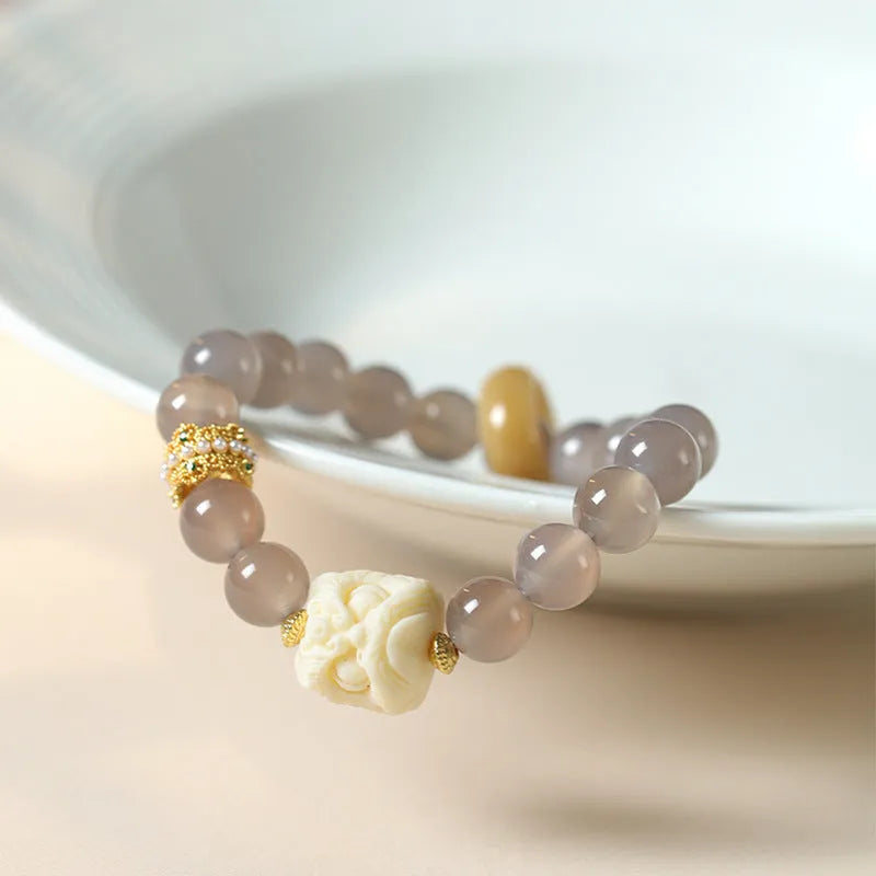 Hand-woven bracelet with 10mm round grey agate and mellite beads on a single strand.