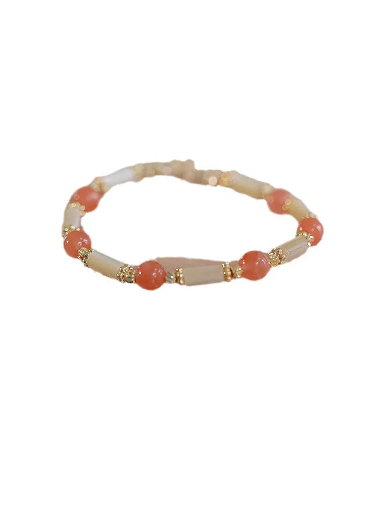 Women's bamboo design bracelet with 6mm Hetian jade beads in either jade or South Red colour.