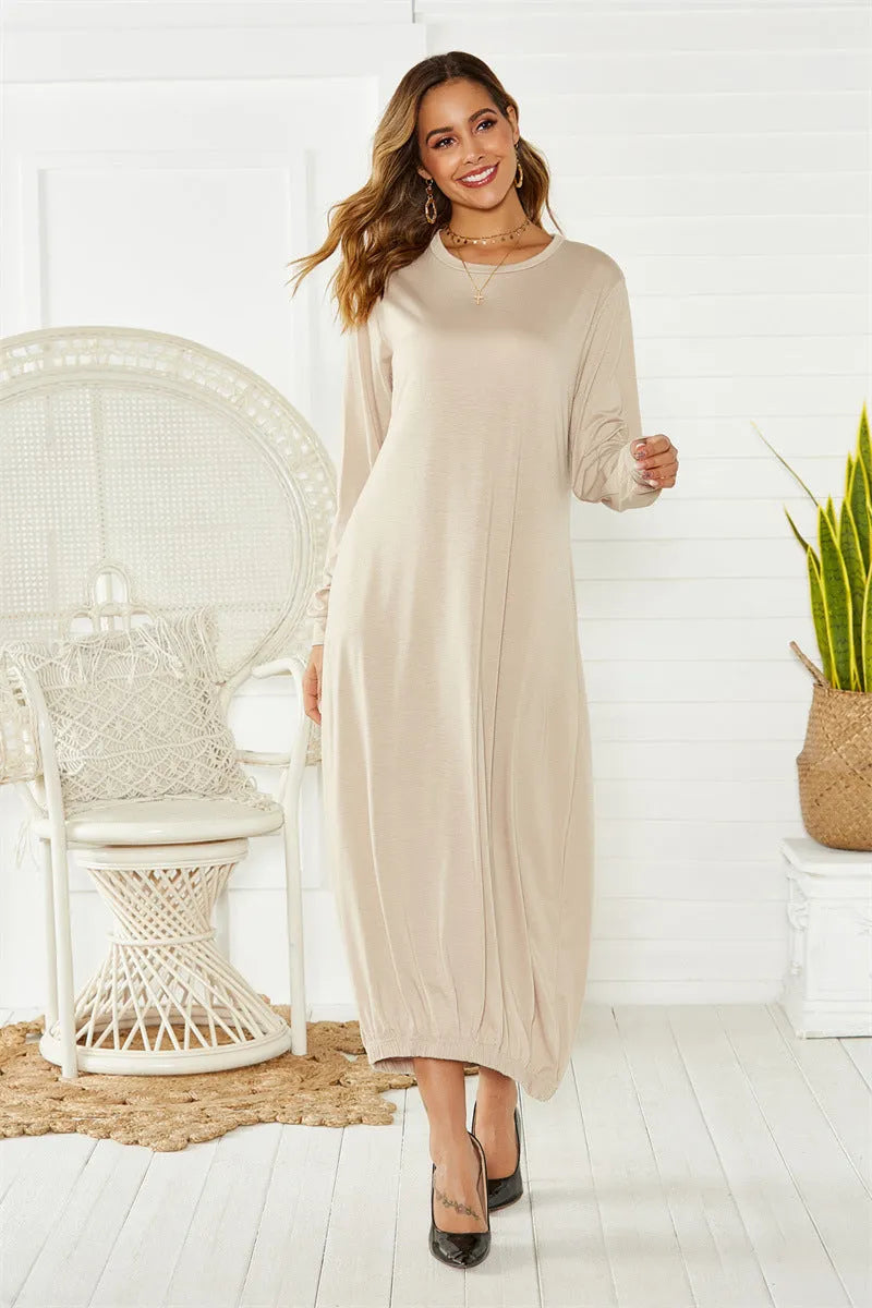 Loose black lantern dress with lace-up crew neck and threads detailing on a mannequin